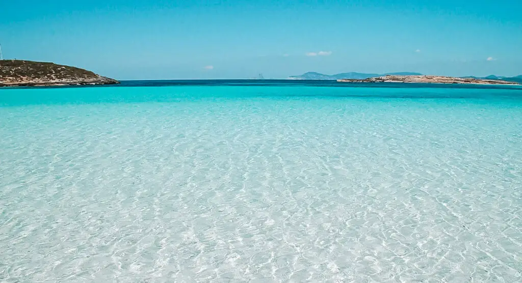 The stunning contrast between the crystal-clear turquoise waters and the powdery white sand creates a truly breathtaking scene.